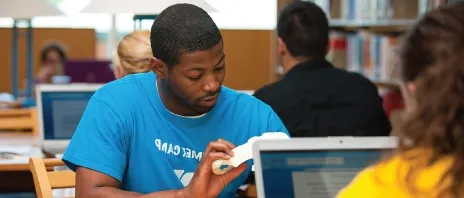 Student utilizing an Anatomy Kit at the St. Ambrose University library.